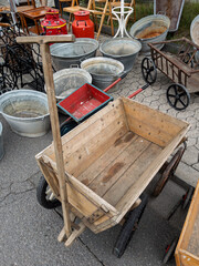 Vintage Wooden Cart at Flea Market Surrounded by Unique Antiques