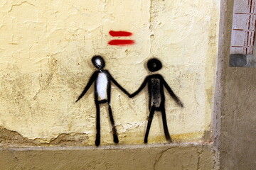 Mural depicting a couple of different races holding hands in Florence, Italy, promoting unity and...