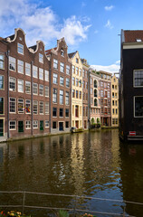 Naklejka premium Oudezijds Voorburgwal Canal De Wallen Amsterdam. De Wallen houses on the Oudezijds Voorburgwal Canal near the Red-Light district in Amsterdam.