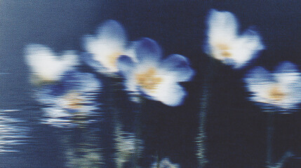 Blurred blue flowers reflected in water create an abstract and dreamy atmosphere in a serene natural setting