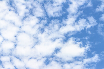 Expansive blue sky filled with fluffy white clouds, creating a serene atmosphere, perfect for...