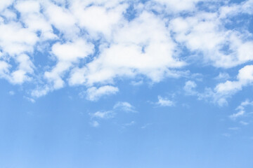 Bright blue sky with fluffy white clouds scattered across the horizon, creating a serene atmosphere...