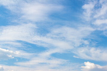 Expansive blue sky filled with soft white clouds, creating a serene atmosphere, ideal for backgrounds or design projects, conveying tranquility and openness