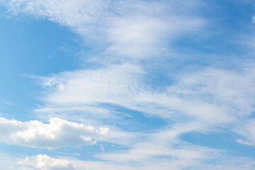 Expansive blue sky with soft white clouds drifting gently, creating a serene atmosphere, ideal for...