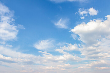 Expansive blue sky filled with fluffy white clouds, creating a serene atmosphere, ideal for backgrounds or design projects with copy space for text overlay