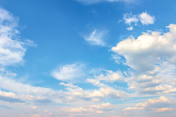 Expansive blue sky filled with fluffy white clouds, creating a serene atmosphere, ideal for...