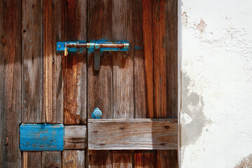 Close up of detailed door and cracked plaster wall in Vila Real do Santo Domingo, Portugal