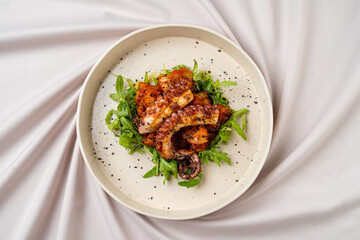 Grilled octopus elegantly plated on a bed of fresh arugula, accompanied by roasted potatoes, showcasing vibrant colors and intricate details that highlight culinary artistry