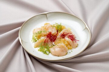A beautifully arranged seafood creation featuring tender scallops paired with vibrant garnishes. The dish showcases a harmony of colors and textures, inviting diners to indulge