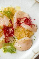 Savor the elegance of a gourmet dish crafted with tender scallops, colorful seaweed, and luxurious citrus caviar, artfully arranged for an upscale dining experience