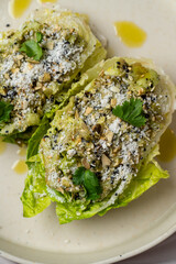 Fresh romaine lettuce embraces a flavorful filling of herbs and nuts, drizzled with olive oil. This vibrant dish captures the essence of summer eating, bursting with fresh tastes
