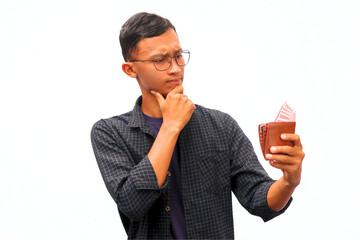 An Asian man holding a wallet full of money with a thinking expression
