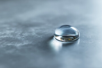Macro close-up of a single water droplet resting on a smooth surface, high detail, sharp focus, photorealistic style,