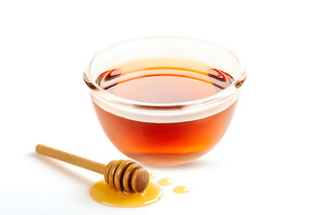 Glass bowl of honey with honey dipper isolated on white background.