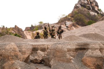 Special Forces Team Standing Together in Desert Mountain Terrain – Tactical Soldiers in Full Gear...