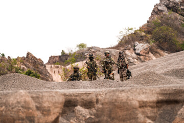 Special Forces Team Standing Together in Desert Mountain Terrain – Tactical Soldiers in Full Gear...