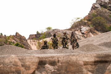 Special Forces Team Standing Together in Desert Mountain Terrain – Tactical Soldiers in Full Gear...