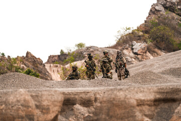 Special Forces Team Standing Together in Desert Mountain Terrain – Tactical Soldiers in Full Gear...