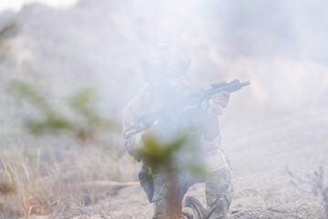 Special Forces Soldier Standing in Smoke During Tactical Operation – Full Combat Gear with Rifle...