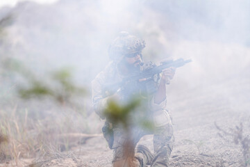 Special Forces Soldier Standing in Smoke During Tactical Operation – Full Combat Gear with Rifle...