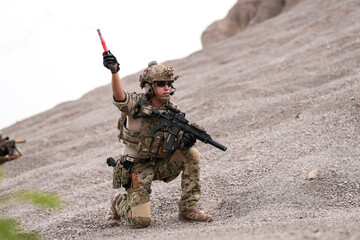Special Forces Team During Military Operation on Rocky Slope – Soldier Holding Red Flare and...