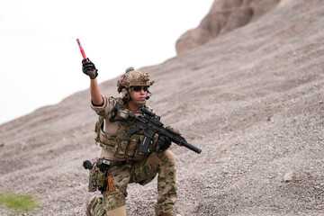 Special Forces Team During Military Operation on Rocky Slope – Soldier Holding Red Flare and...