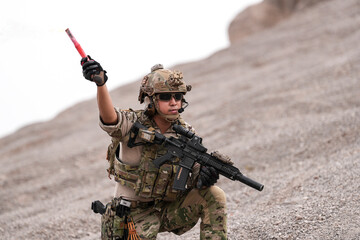 Special Forces Team During Military Operation on Rocky Slope – Soldier Holding Red Flare and...