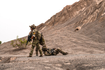 Three Soldiers in Combat Gear Holding Tactical Positions on Rocky Terrain – Realistic Military...