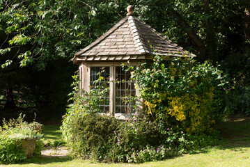 Cheshire England UK. 01.06.2025. Small summer house in an English country garden.