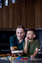 Mother and her son eating freshly baked gingerbread together