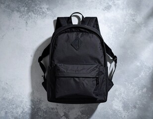 Matte Black Backpack on Concrete Background – Top View
