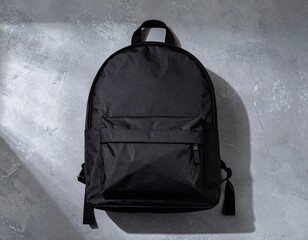 Matte Black Backpack on Concrete Background – Top View