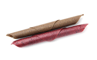 Delicious fruit leather rolls on white background, top view