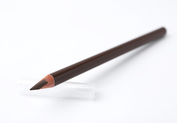 Brown eyebrow pencil on white background, closeup