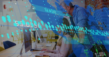 Collaborating office professionals typing and pointing at computers in open office, showing data