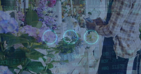 Scanning florist in plaid shirt and apron using tablet at counter, with hydrangeas copy space