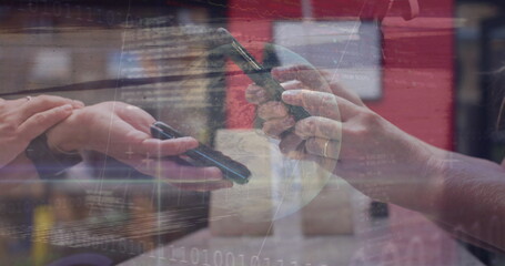 Exchanging smartphones, two women colleagues sharing digital data in tech office, binary overlay