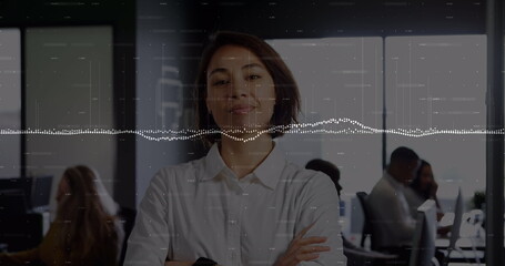 Standing adult female professional crossing arms in open plan office, with waveform overlay