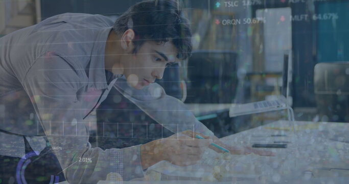 Sketching Native American man annotating paper on white desk in modern office, with teal pen - Powered by Adobe