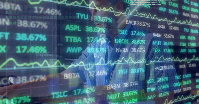 Monitoring trader wearing blue shirt, tracking stock market at office desk, with monitor and mug - Powered by Adobe