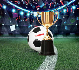 Football championship. Shiny golden trophy cup and soccer ball under falling confetti on stadium