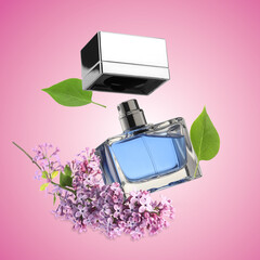 Bottle of floral perfume and blossoming lilac in air on pink gradient background