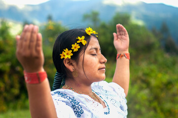 Indigenous woman wearing traditional clothes performing a ritual in nature