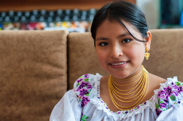 Smiling indigenous girl wearing traditional clothes and jewelry