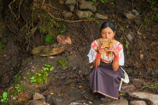 Musician playing andean zampo&ntilde;a flute in otavalo, ecuador