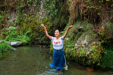 Indigenous woman performing ritual in a sacred natural spring
