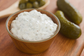 Fresh homemade tartar sauce made of mayonnaise, pickles, capers, herbs, salt and pepper, served in small bowl (Selective Focus, Focus on the front of the sauce)