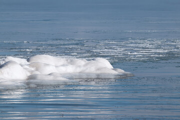 Chunk of snow and ice in blue lake