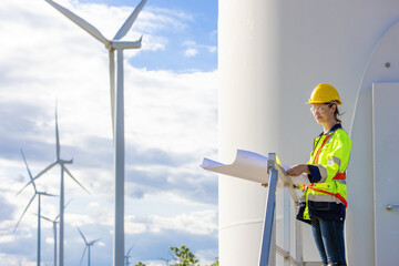 Engineer  woman working with blueprint survey plan construction wind turbine sustainable clean...