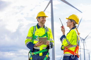 Engineer team man and woman working together with tablet,  survey plan construction wind turbine...